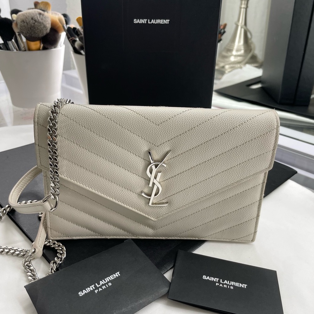 White YSL wallet on chain bag.